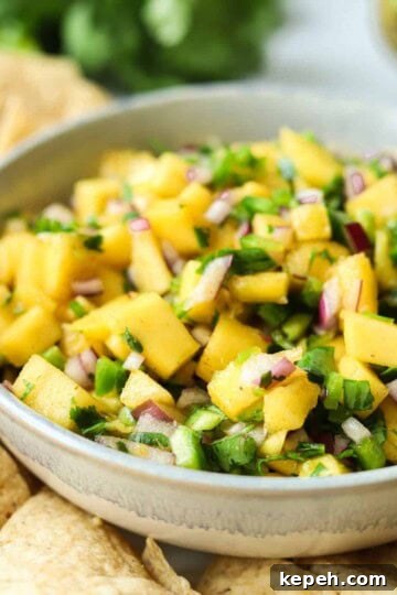 mango pico de gallo in bowl with tortilla chips