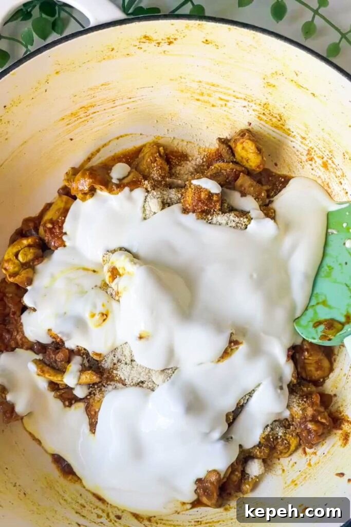 Yogurt added to pan with chicken and spices.