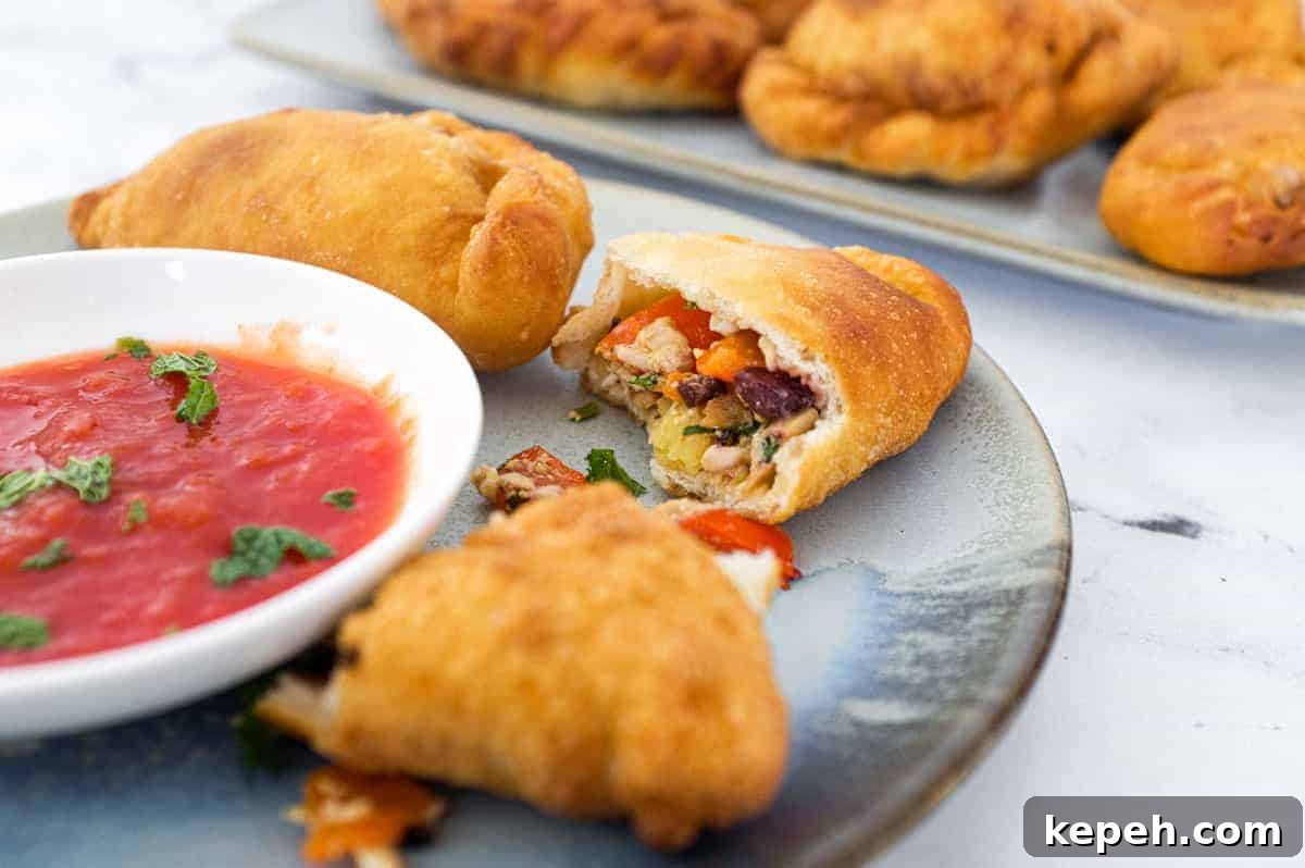 Mini Panzerotti: Tuna, Olive & Roasted Red Pepper Calzone 2 Folding the Panzerotti dough using a rolling seal technique like a pasty.