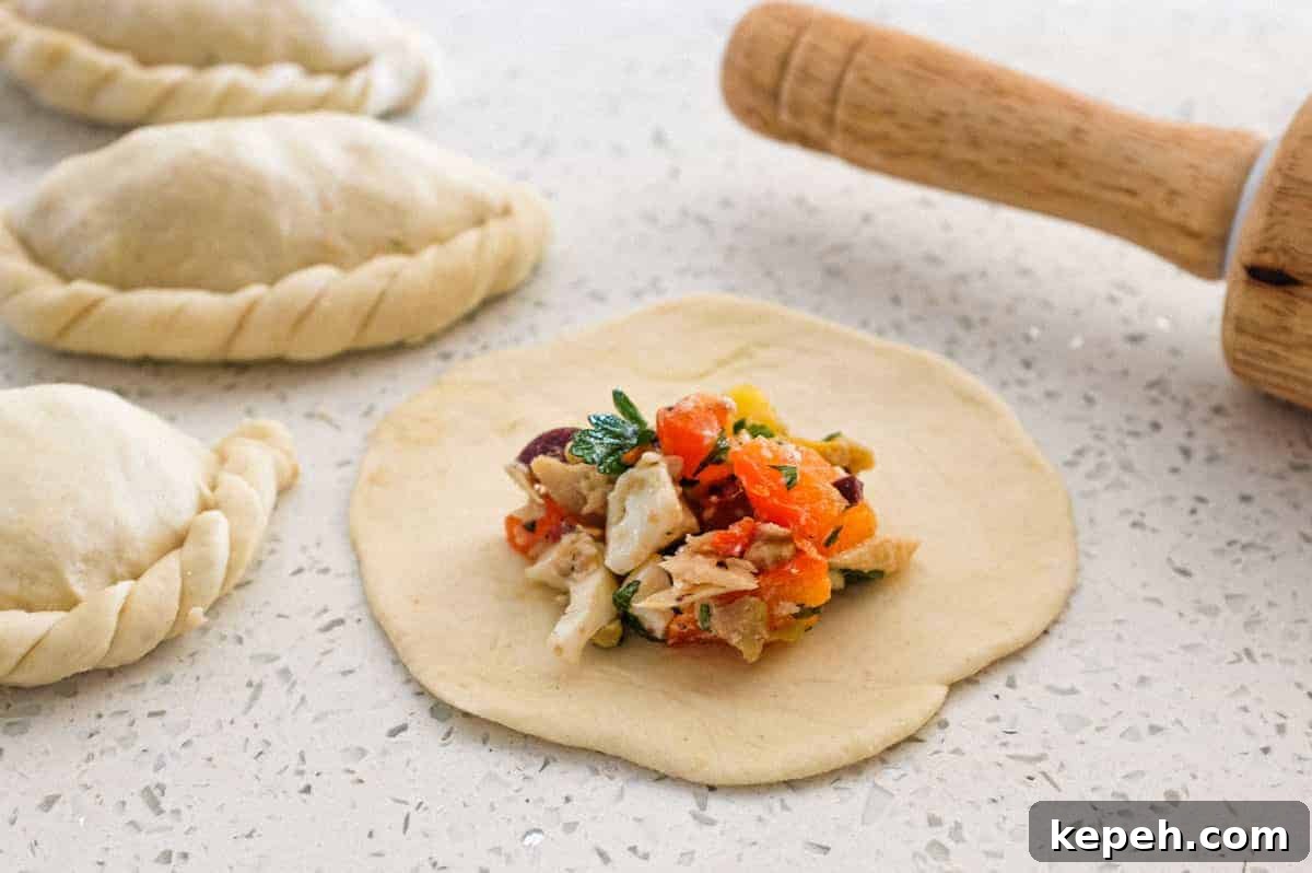 Panzerotti | www.cookeatworld.com Panzerotti dough circle with the filling on top, small folded panzerotti surround the non folded version