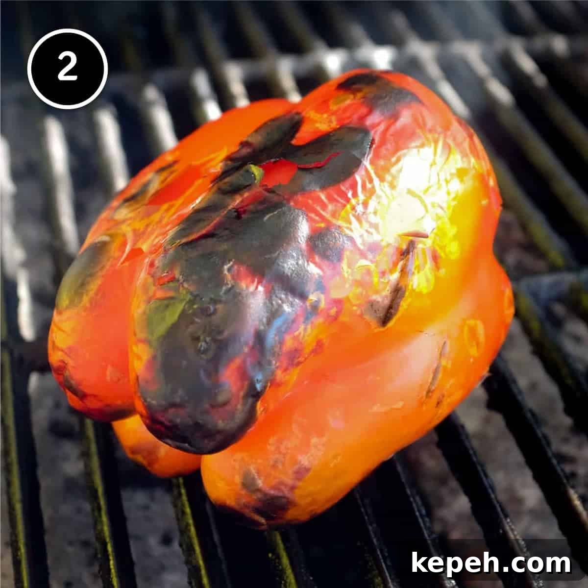 Panzerotti (mini calzone pizza with tuna & red peppers) | www.cookeatworld.com A red bell pepper roasting on a grill for Panzerotti pizza