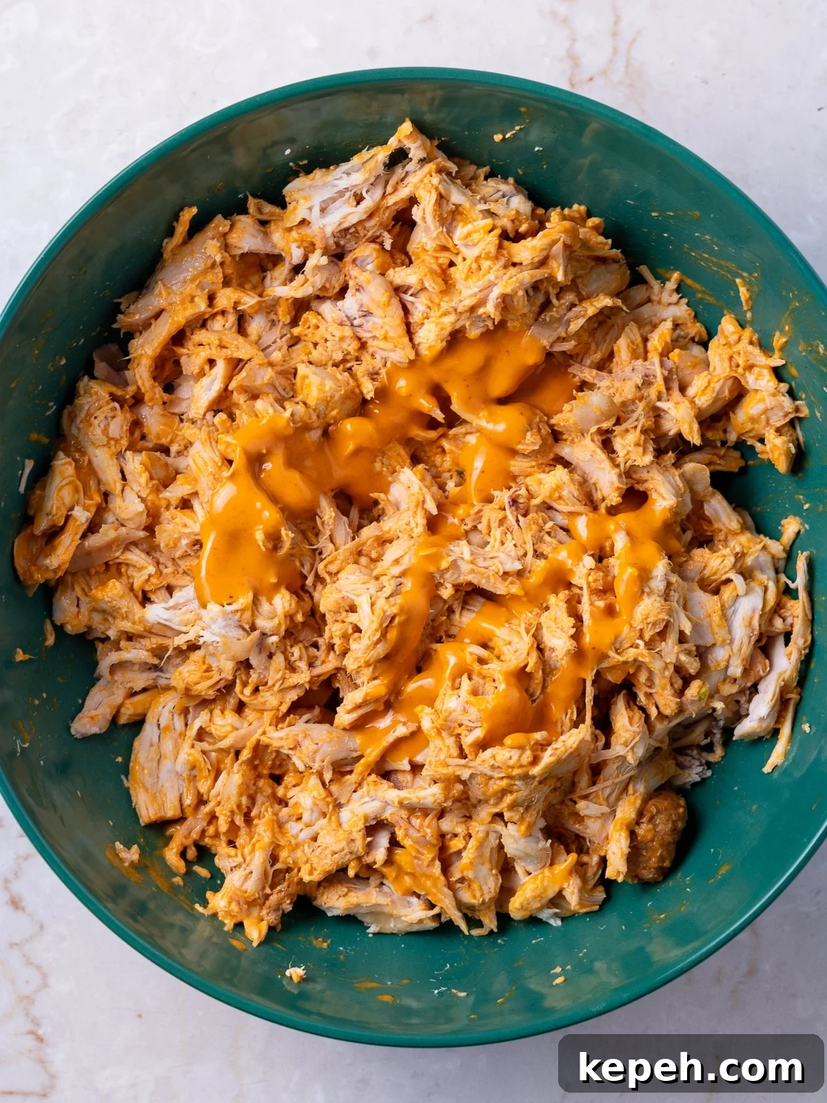 bowl with shredded chicken and buffalo sauce