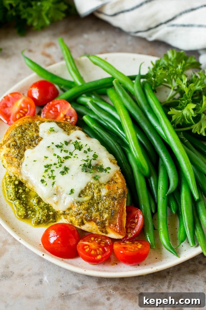 A plate of pesto chicken served with green beans. A plate of pesto chicken served with green beans.