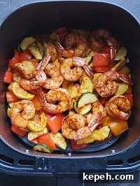 air fryer Cajun shrimp inside air fryer basket