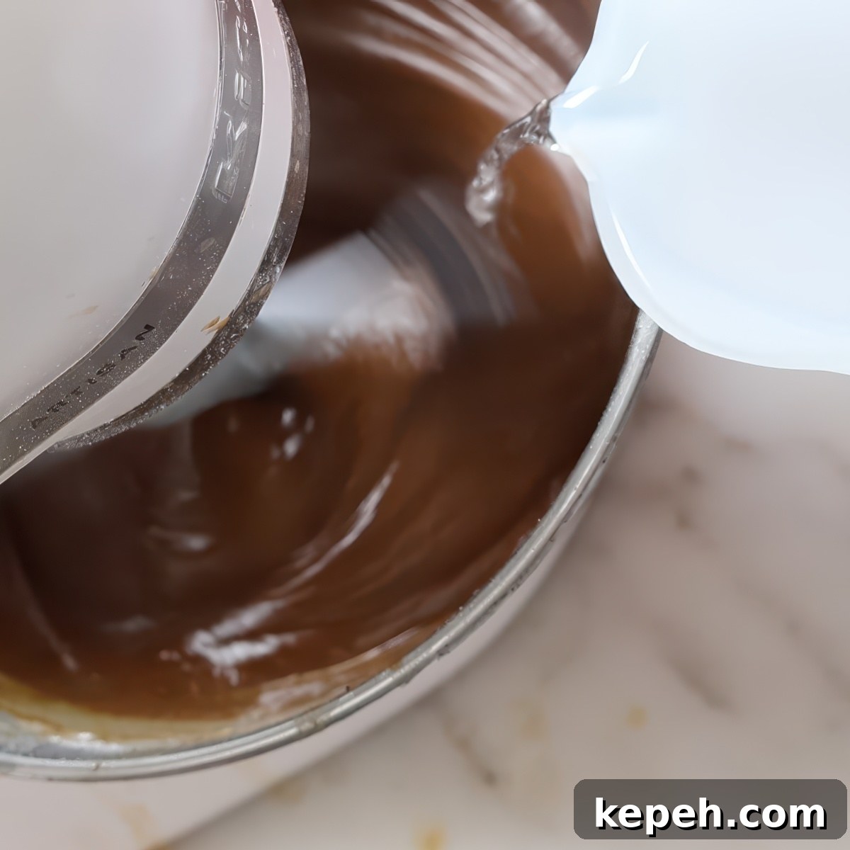 Gluten-Free Gingerbread Loaf Recipe That Delights 8 pouring water into mixing brown batter in stand mixer.