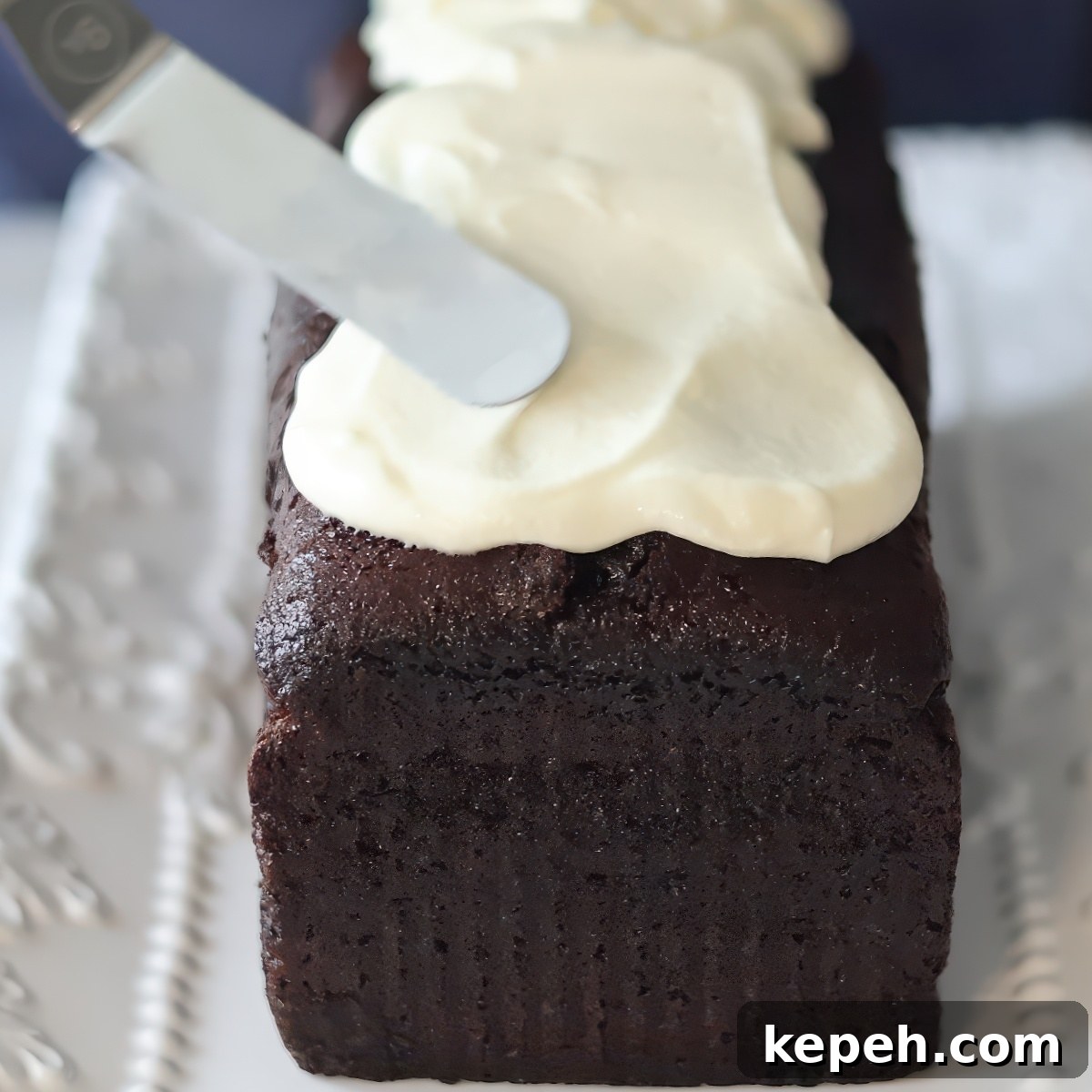 Gluten-Free Gingerbread Loaf Recipe That Delights 10 frosting dark loaf cake with white frosting.