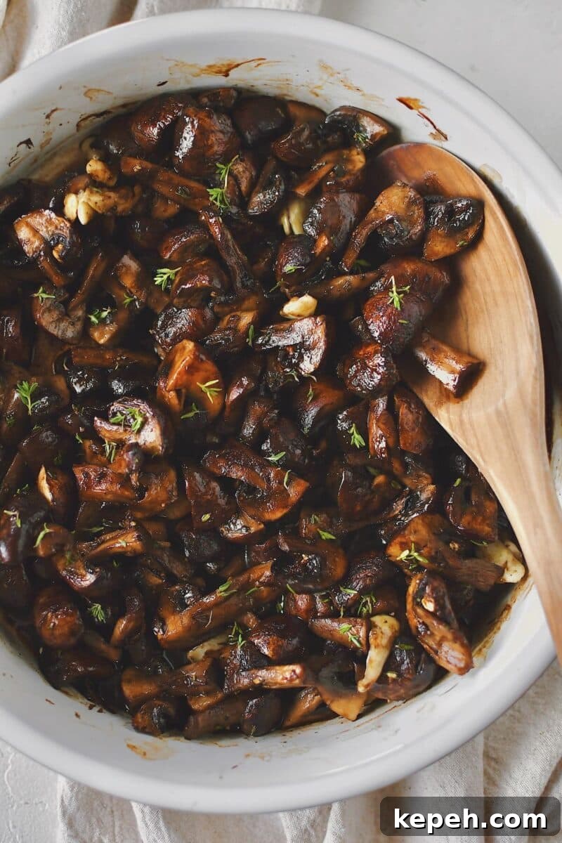 Mushrooms, tossed with olive oil, seasoning, garlic, and thyme, after roasting.