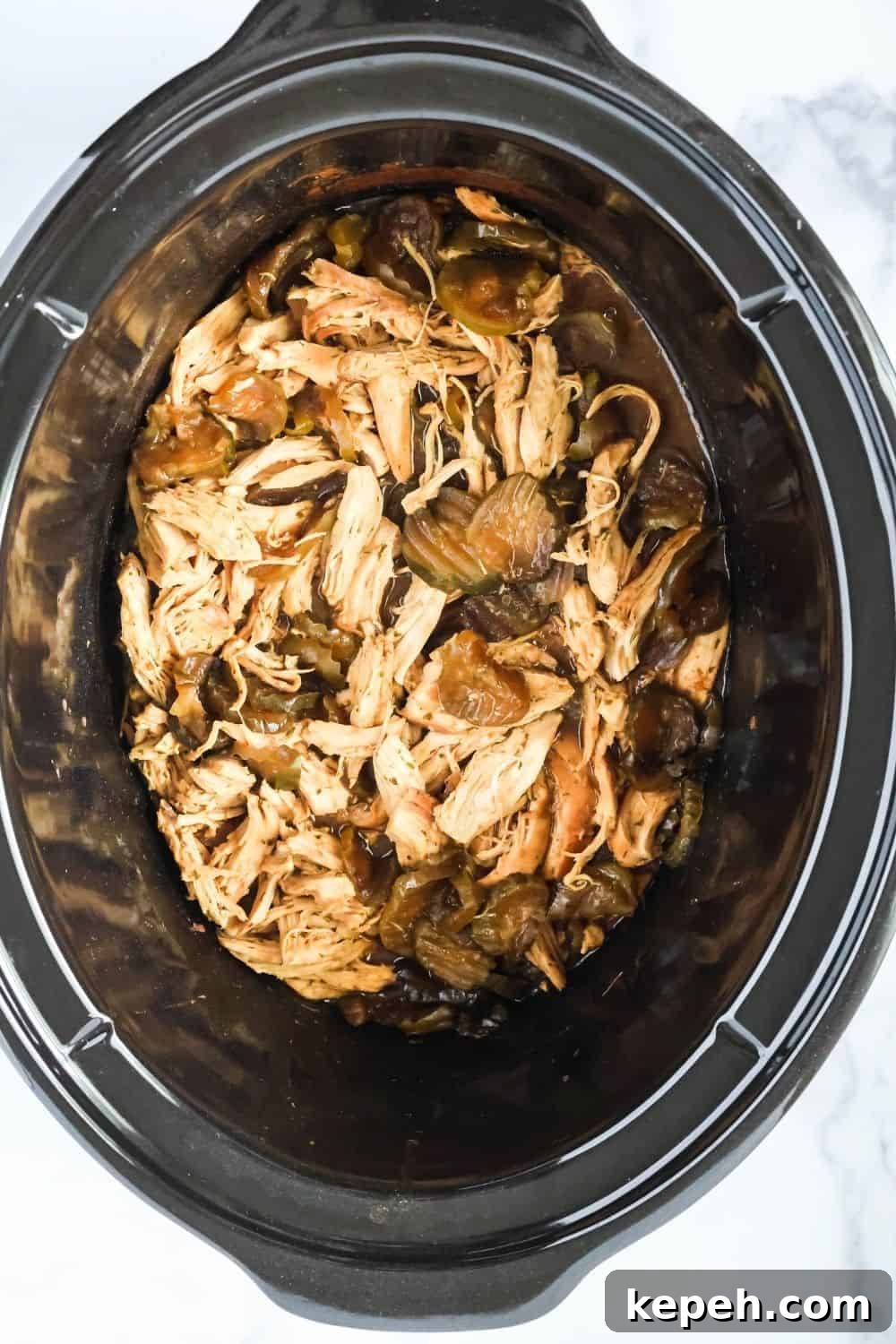 overhead view of a slow cooker liner filled with dill pickle chicken.