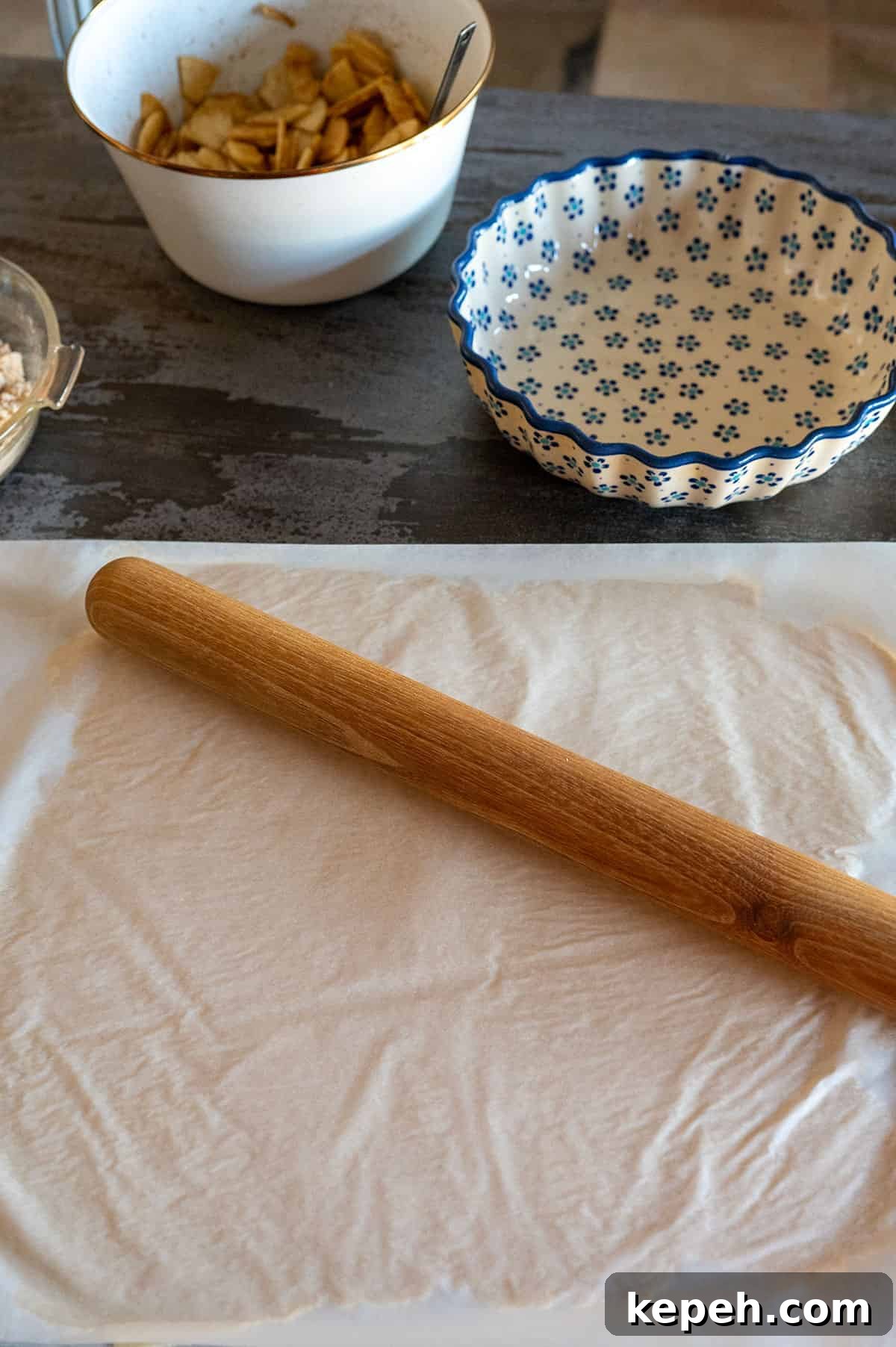 Flaky Pie Crust Recipe for Sweet and Savory Pies 8 rolling dough between two sheets of parchment paper.