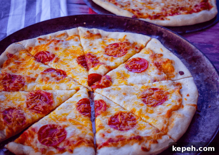 Pepperoni Pizza cut into slices on a pizza pan. 