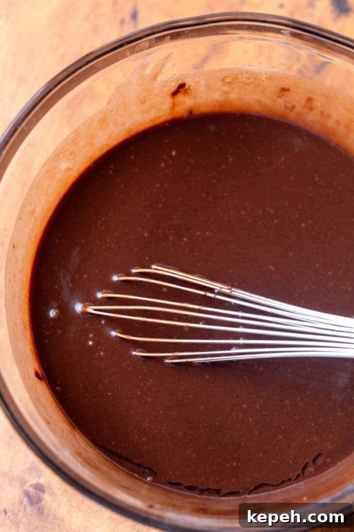 Authentic German Chocolate Cake Recipe for Decadent Dessert 4 Wet ingredients in a bowl.