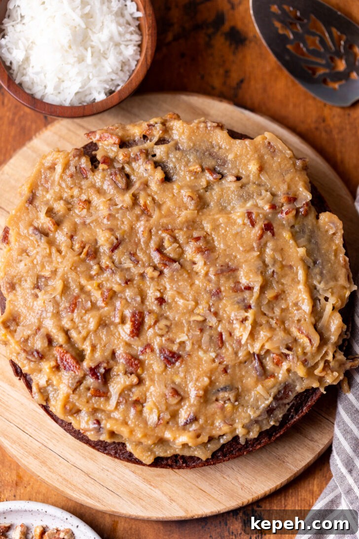 Authentic German Chocolate Cake Recipe for Decadent Dessert 9 Coconut pecan frosting on top of cake.