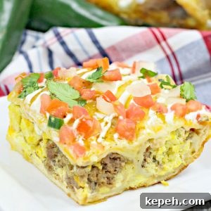a casserole filled with eggs and chorizo and topped with tomatoes and cilantro on a white plate.