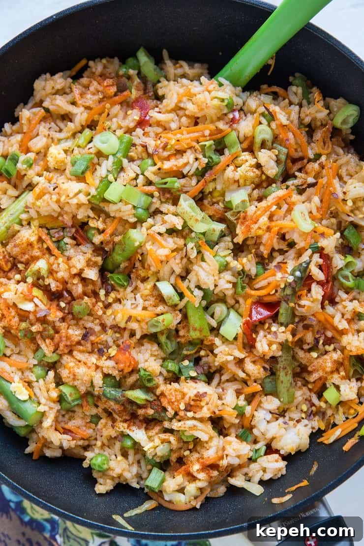 Vegetable Red Curry Fried Rice - Thai style fried rice with red curry paste, bell pepper, carrot, asparagus, green onion, and more