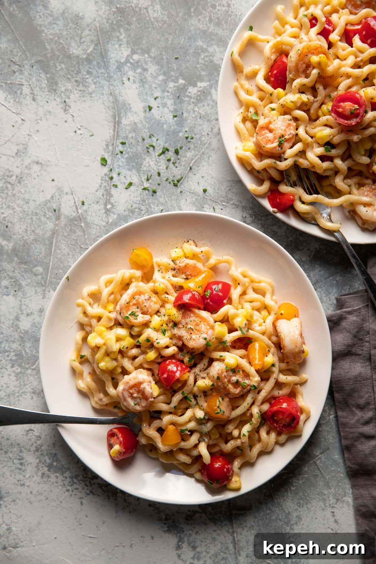 Creamy Summer Shrimp Pasta Recipe for Light, Zesty Meals 3 fusili pasta with shrimp corn and tomatoes on a plate