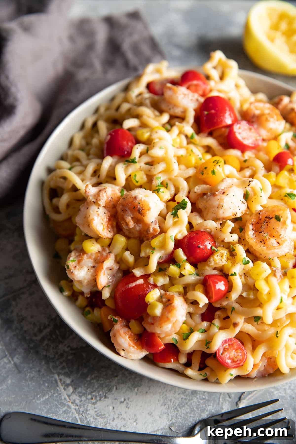 Creamy Summer Shrimp Pasta Recipe for Light, Zesty Meals 6 fusili pasta with shrimp corn and tomatoes in a bowl