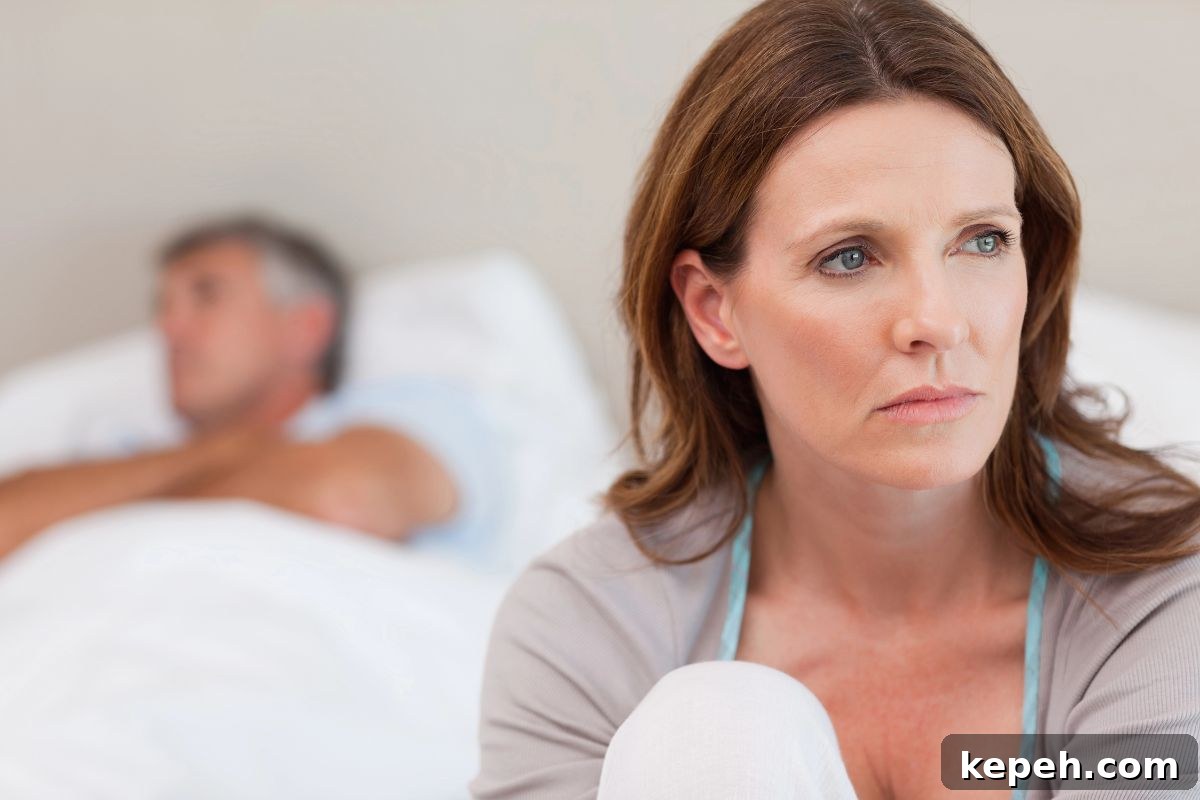 15 Dog Breeds Perfect for Companionship in Your Later Years 17 Woman looking sad with her husband in bed sleeping