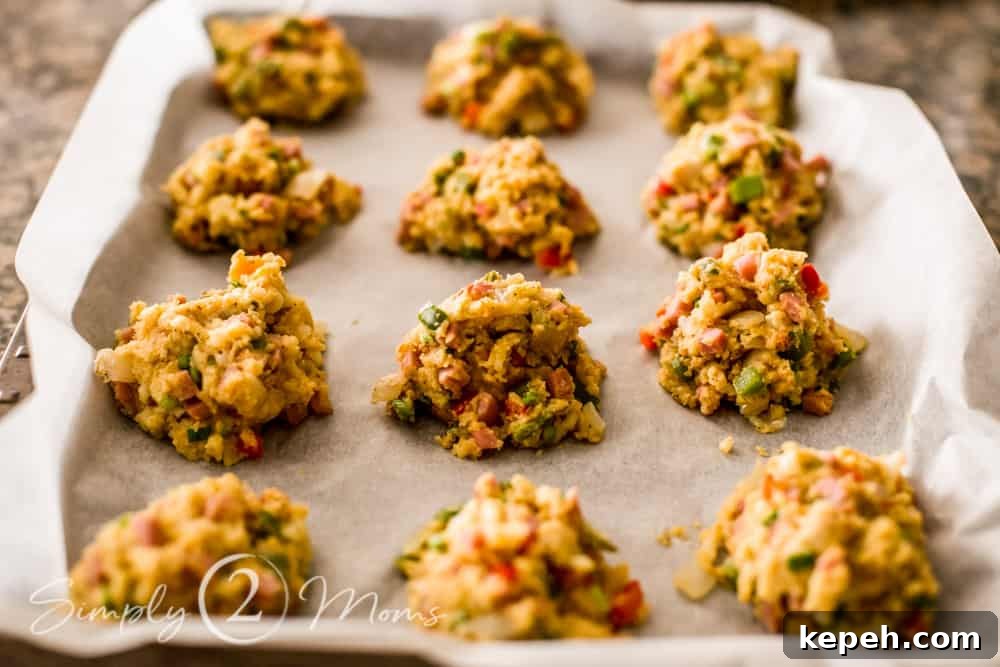 cookie sheet lined with parchment paper with unbaked keto southwest breakfast biscuits