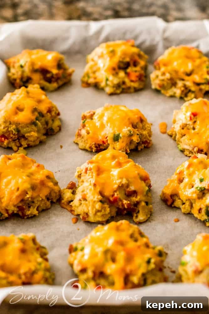cookie sheet lined with parchment paper with baked keto southwest breakfast biscuits