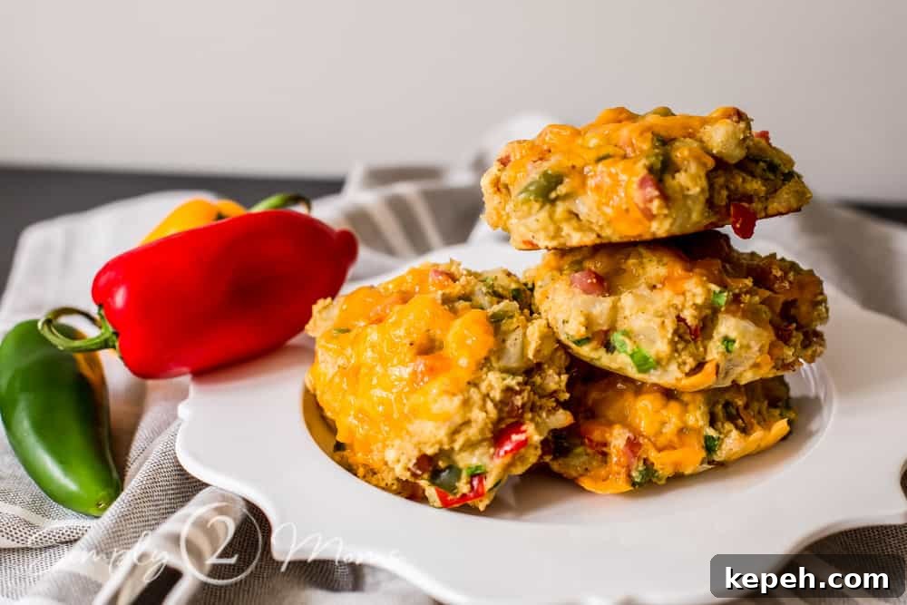 stack of keto southwest breakfast biscuits on a scalloped plate garnished with mini bell peppers