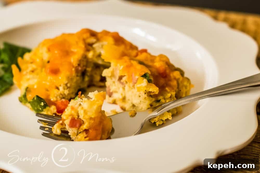 a keto southwest breakfast biscuit with a fork on a scalloped plate