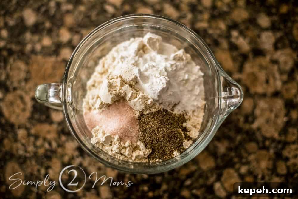 overhead view of a mixing bowl with dry ingredients layered
