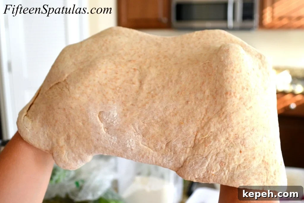 Stretching Pizza Dough in Air With Knuckles