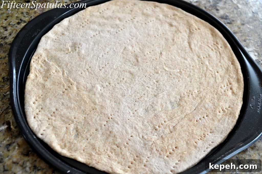 Pricked Pizza Dough on Pizza Pan