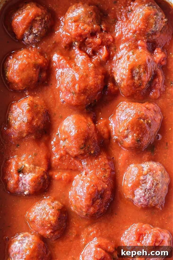 Slow Cooker Meatballs cooking Slow Cooker Meatballs and Sauce in a crock pot
