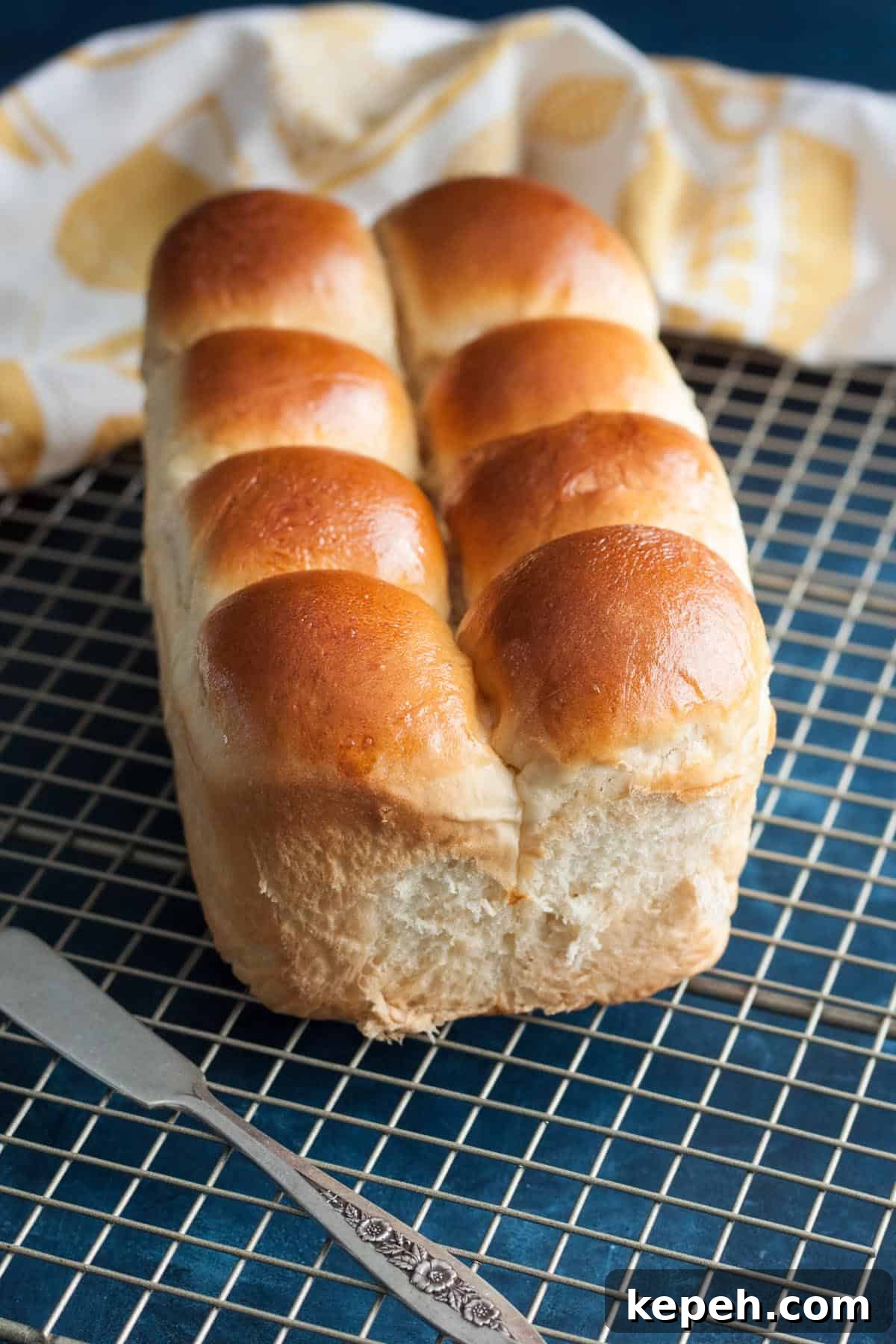 A loaf of Asian milk bread on a wire rack. A loaf of Asian milk bread on a wire rack.