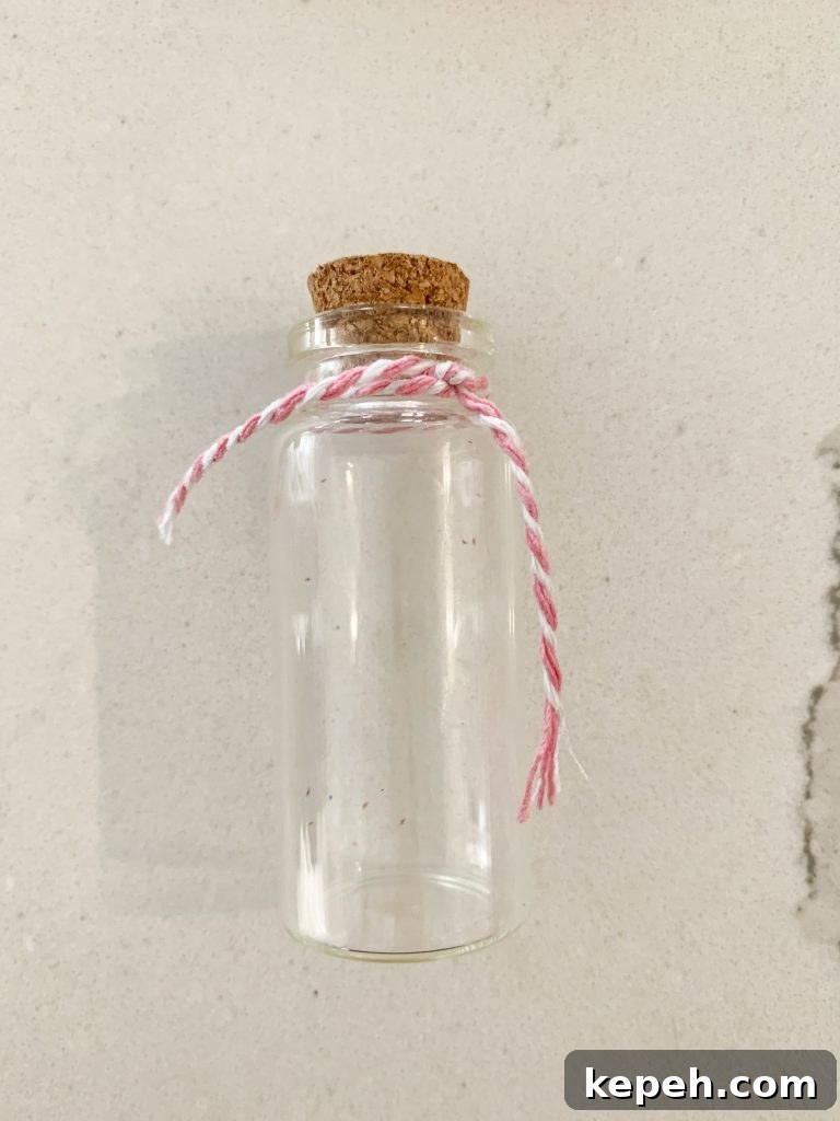 empty mini jar with pink string around it