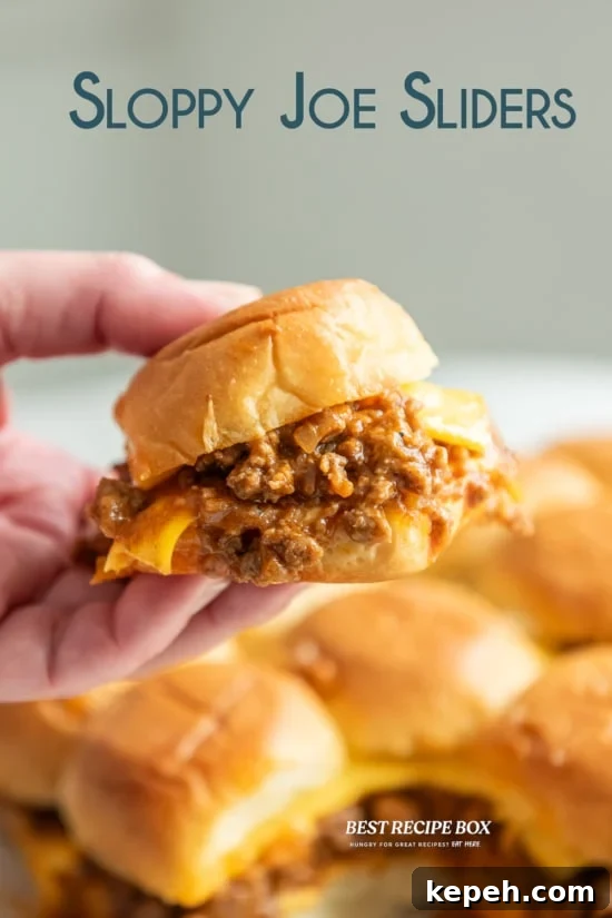 holding sloppy joe sliders with melting cheese