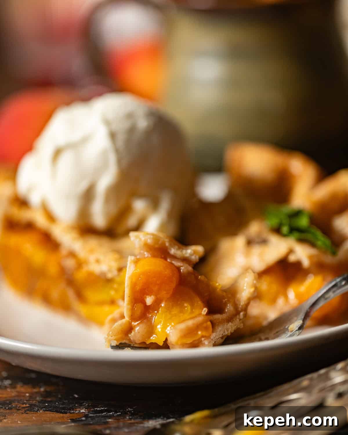 Perfect Peach Pie Recipe Using Canned Peaches 3 up close photo of peach pie on a fork.