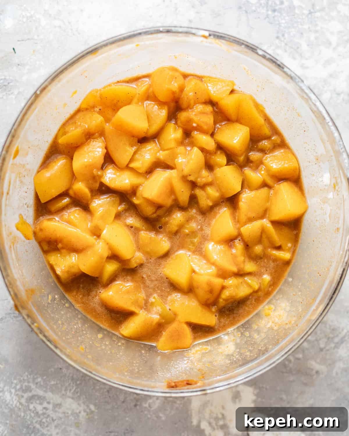 Perfect Peach Pie Recipe Using Canned Peaches 4 canned peaches in a bowl with cornstarch, lemon juice, sugar, and spices.