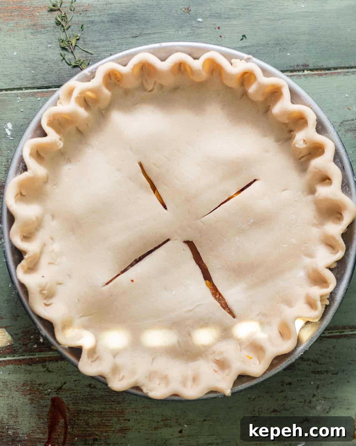Perfect Peach Pie Recipe Using Canned Peaches 7 peach pie assembled in a pie pan with the top pie crust on top with slits in the middle.