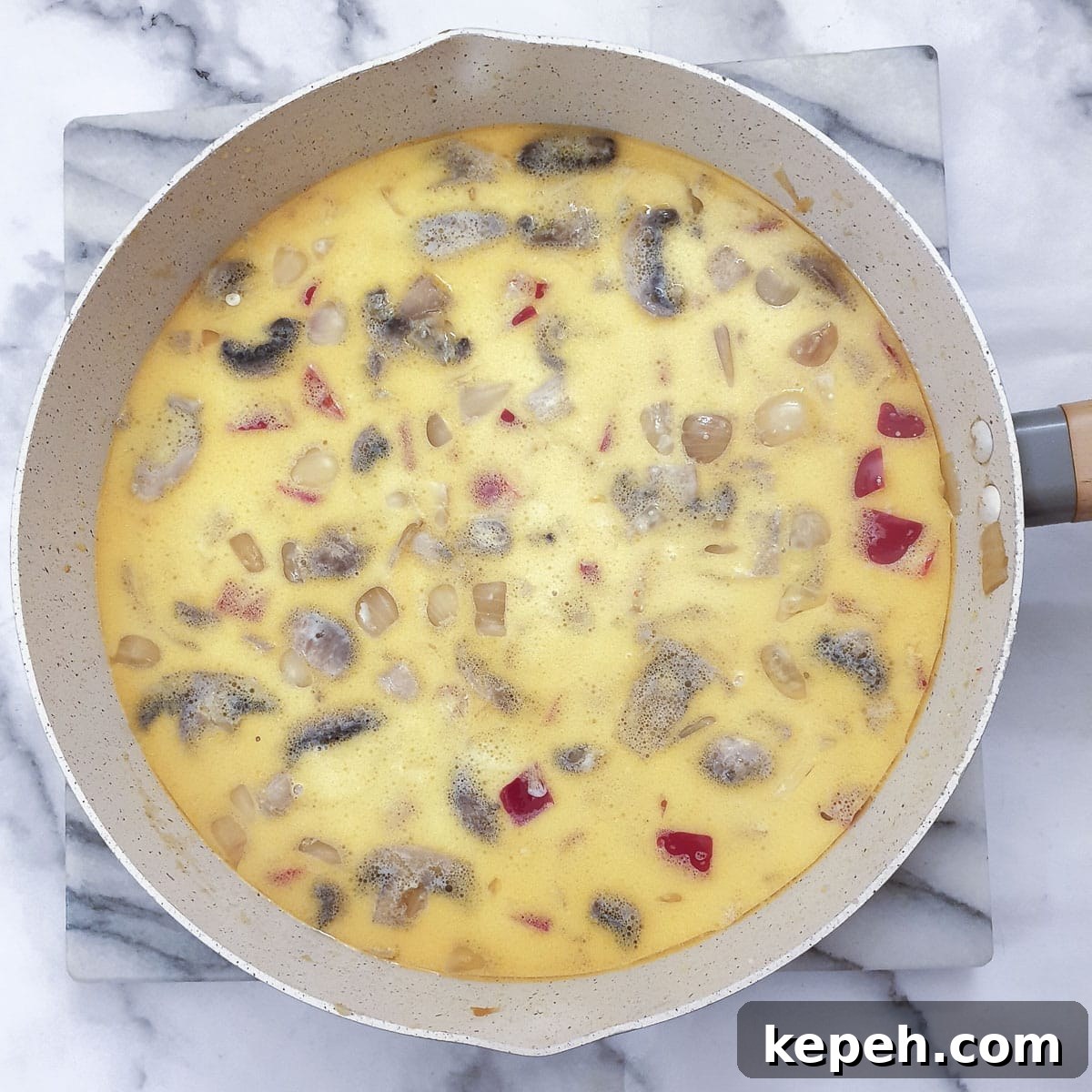 Classic Chicken à la King Recipe: Creamy One-Pot Dinner 11 Milk added to the vegetables in a frying pan.