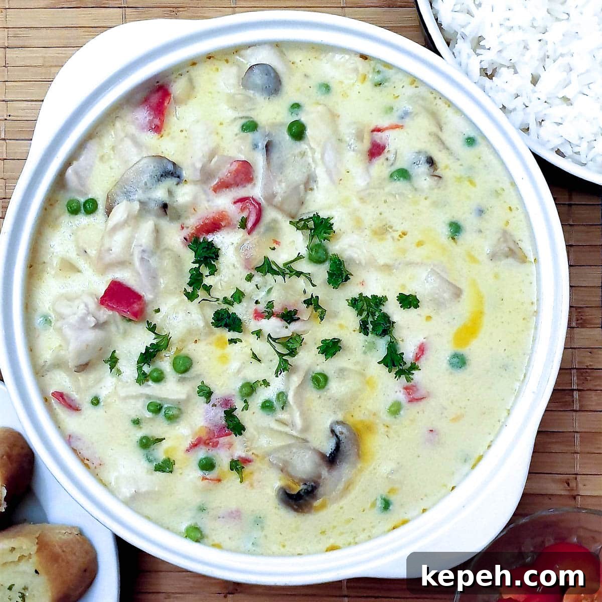 Classic Chicken à la King Recipe: Creamy One-Pot Dinner 3 Overhead shot of chicken a la king in a white serving dish.