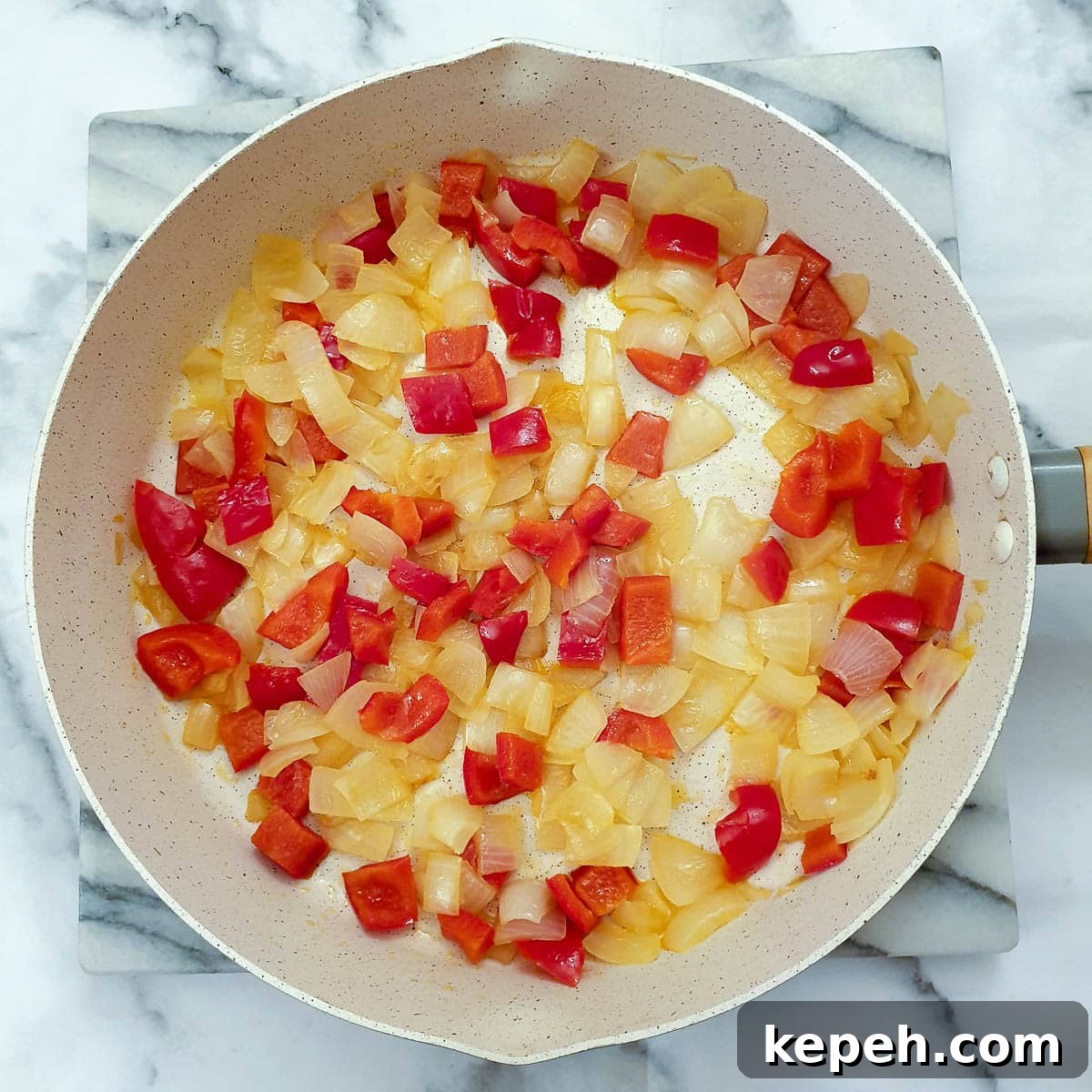 Classic Chicken à la King Recipe: Creamy One-Pot Dinner 8 Red peppers and onions in a frying pan.