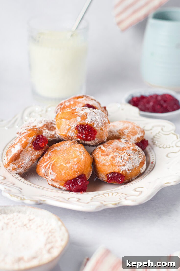 a white plate filled with the finished Air Fryer Jelly Donuts.