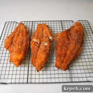 Crispy Southern Fried Catfish Recipe with Tangy Remoulade 9 Fried catfish cooling on a wire rack.