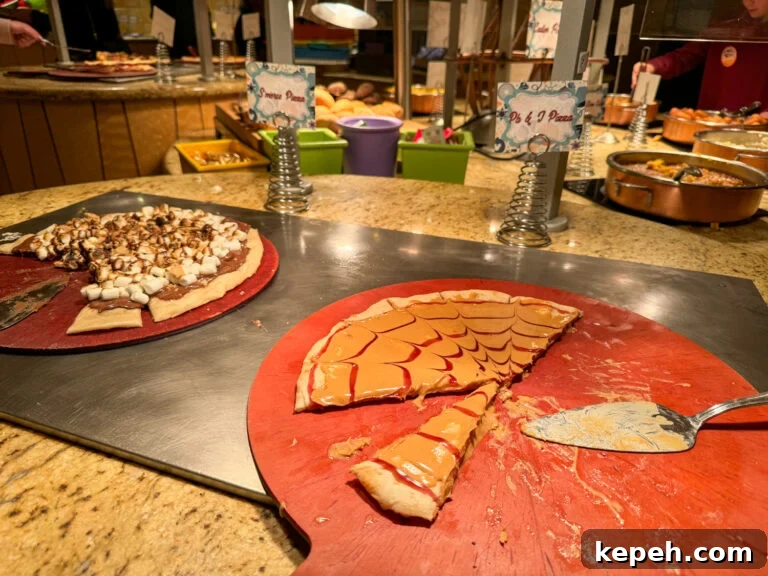 Smores pizza and peanut butter and jelly pizza under a warming light.
