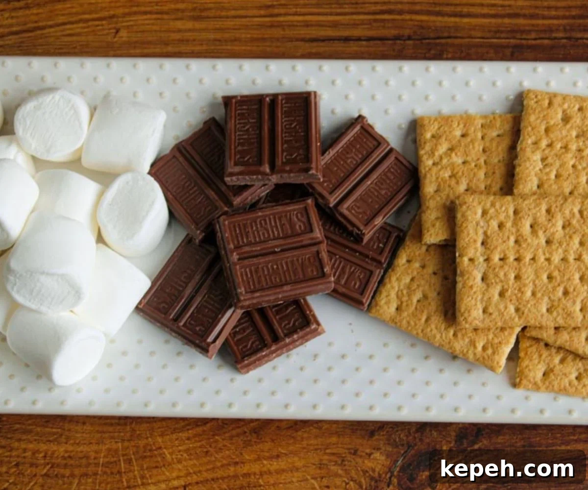 Marshmallows, chocolate squares, and graham crackers on a serving platter.
