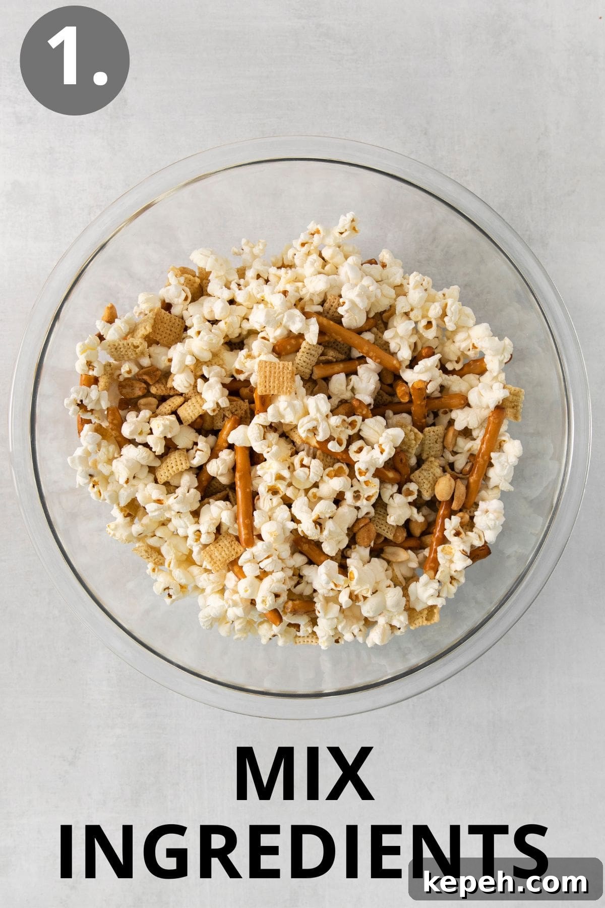Spooky Halloween Snack Mix Recipes for Party Treats 4 Snack ingredients mixed in a glass bowl