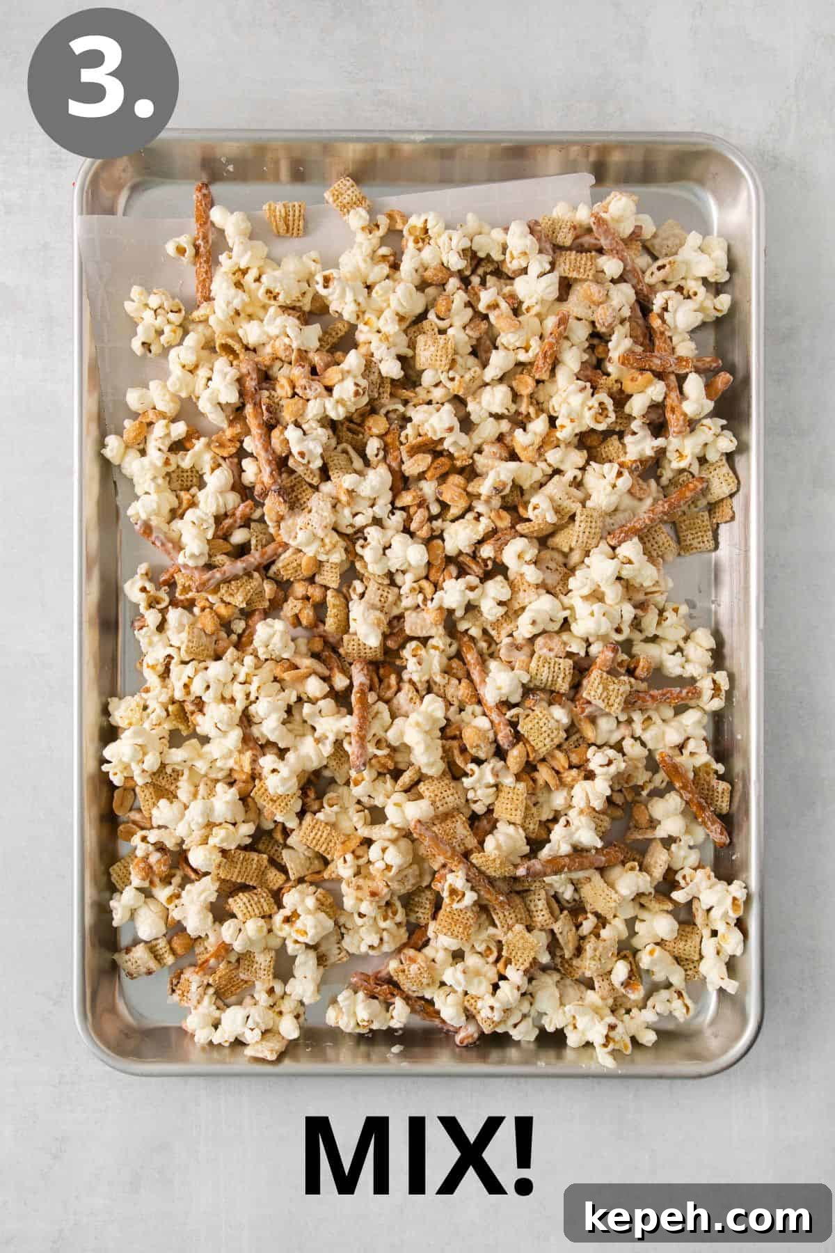 Spooky Halloween Snack Mix Recipes for Party Treats 6 Snack mix spread on a baking sheet