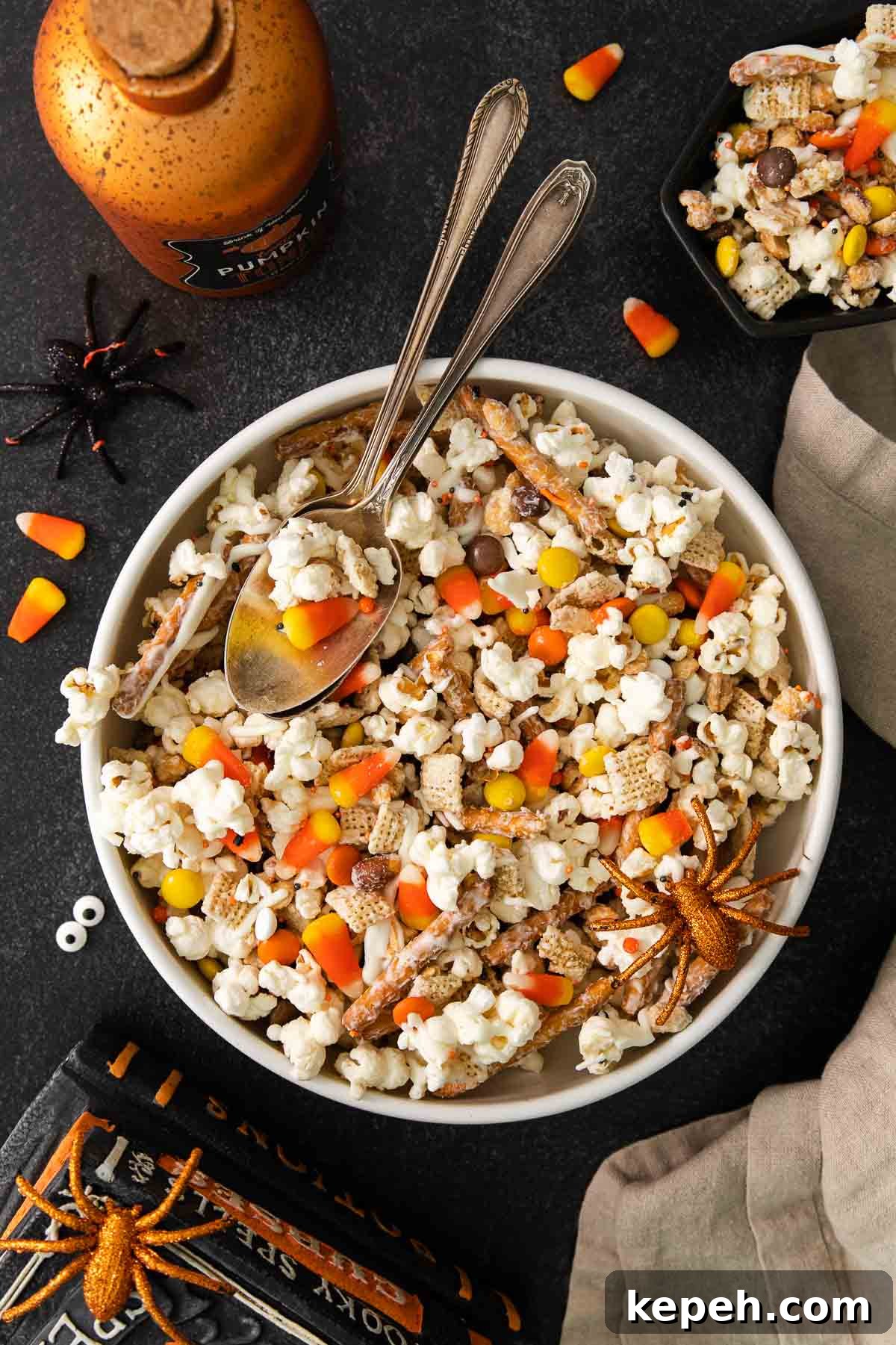 Spooky Halloween Snack Mix Recipes for Party Treats 9 Halloween snack mix in a bowl on a decorated table