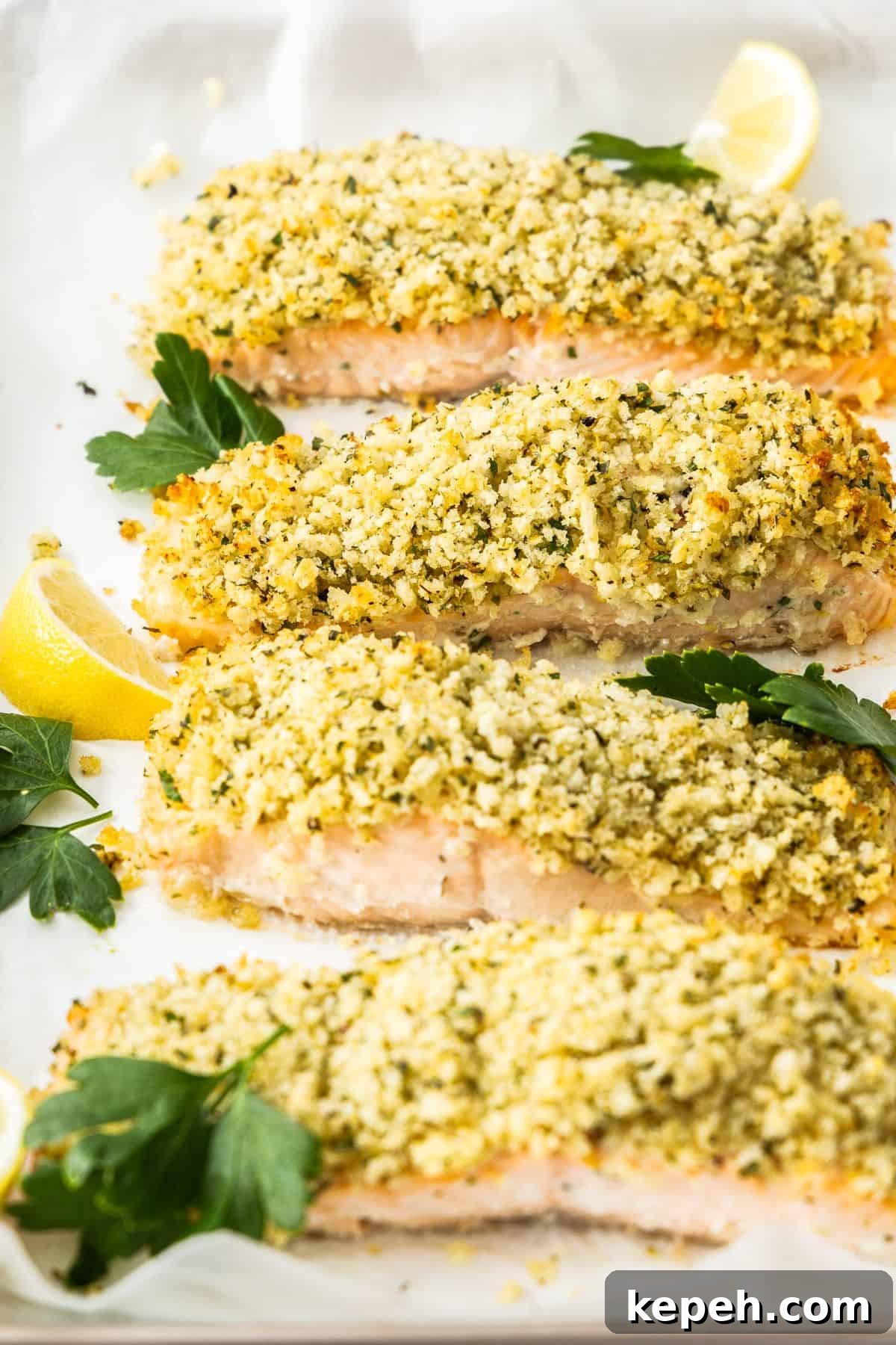 Top Easter Main Courses for a Memorable Holiday Meal 13 Baking tray with cooked Herb Panko Salmon, garnished with some parsley leaves and lemon wedges.