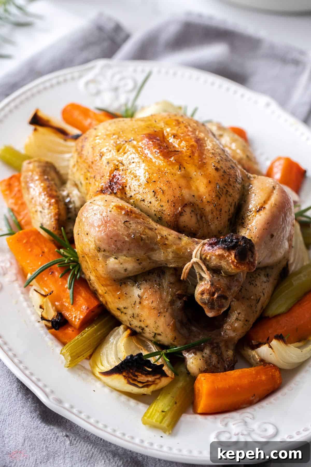 Top Easter Main Courses for a Memorable Holiday Meal 16 White oval plate with Roast Chicken in the centre, and some vegetables around the edge.