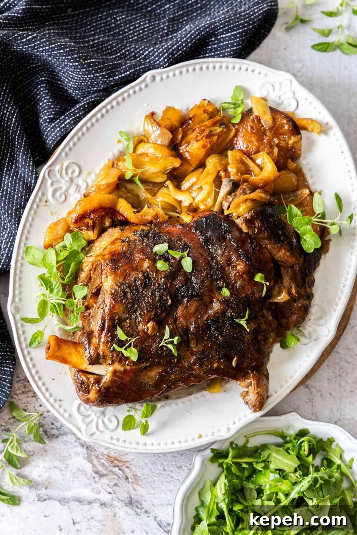 Top Easter Main Courses for a Memorable Holiday Meal 3 Large white platter with the Slow Roasted Lamb Shoulder, garnished with the roasted lemon, fennel and fresh oregano.
