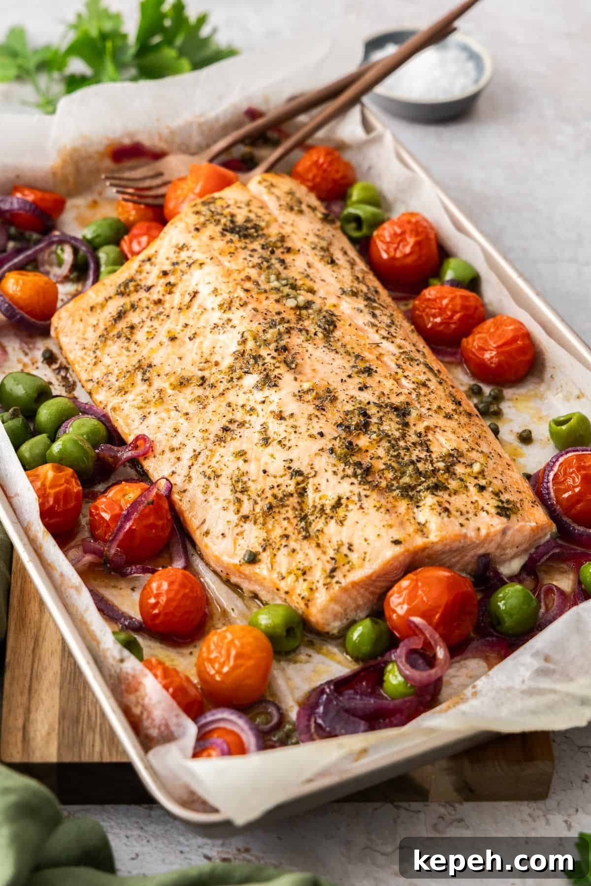 Top Easter Main Courses for a Memorable Holiday Meal 7 Sheet pan with side of Mediterranean Salmon and vegetables around the edge, with serving utensils.
