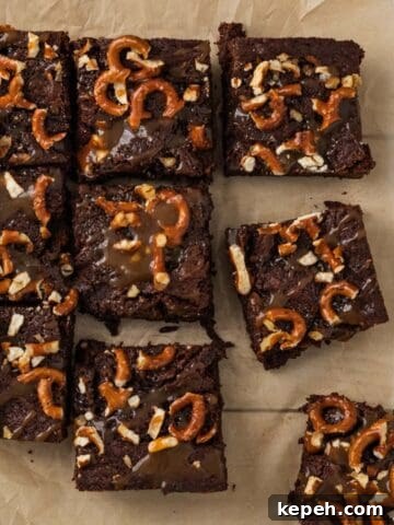 brownies topped with salted caramel and pretzels cut into squares